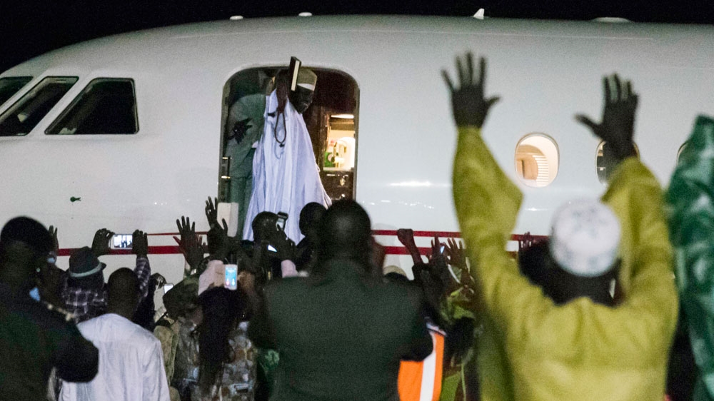 
Jammeh waves to supporters as he boards a plane to leave the country [AFP]
