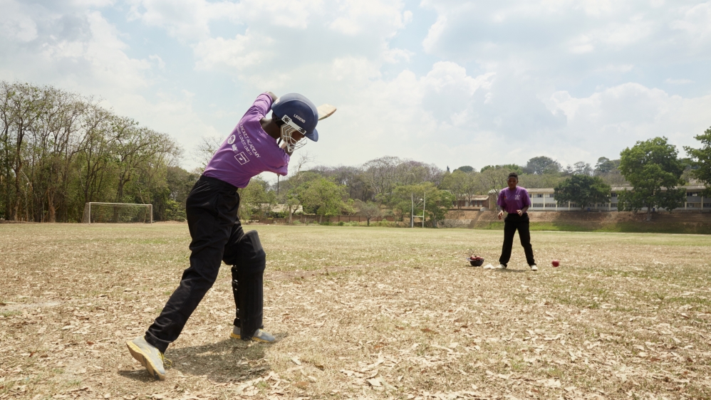 Captain Shahida Hussein reacts as one of her teammates hits a ball during fielding practice while training on the cricket pitch [Julia Gunther/Al Jazeera]