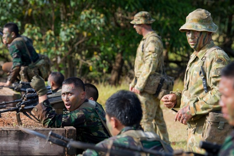 FILE PHOTO: Australian and Indonesian Army soldiers prepare for a charge on the bayonet assault course conducted by the Australian Army''s Combat Training Centre in Tully, Australia
