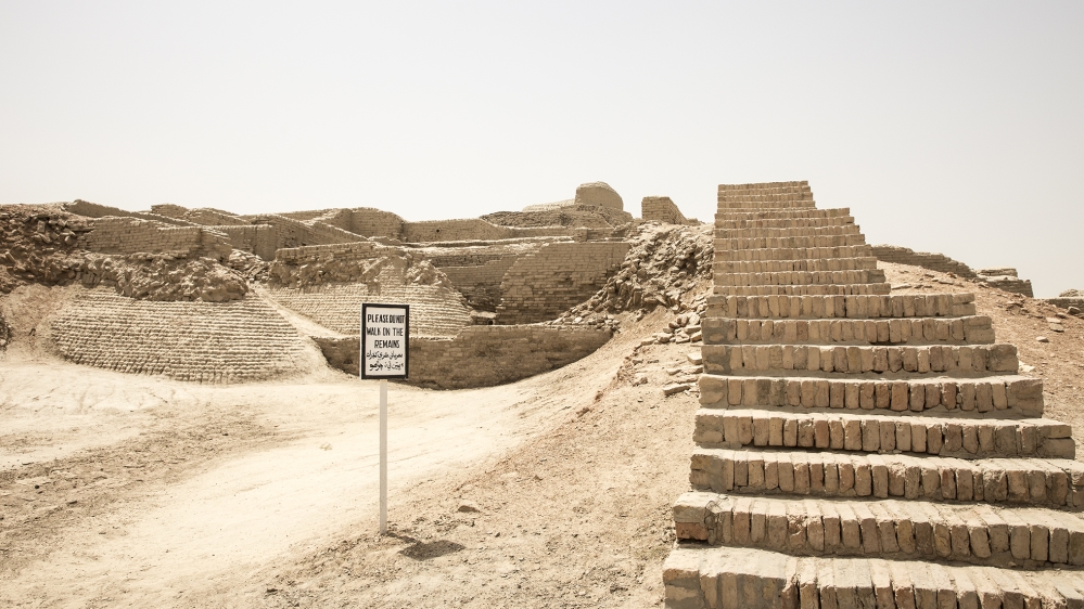 The reminder to stay off the remains is often disregarded by the visitors [Faras Ghani/Al Jazeera]
