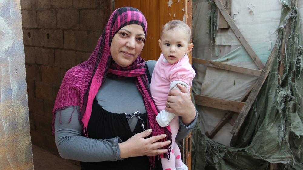 Souafa Abbas and her baby daughter have been living in a temporary shelter since 2007 [Stephen Starr/Al Jazeera]