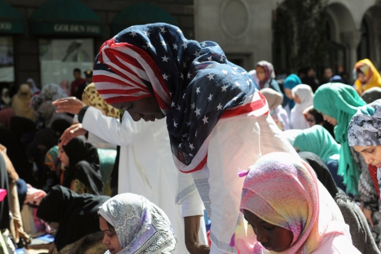 Women pray before the start of the annual Muslim Day Parade in the Manhattan borough of New York City