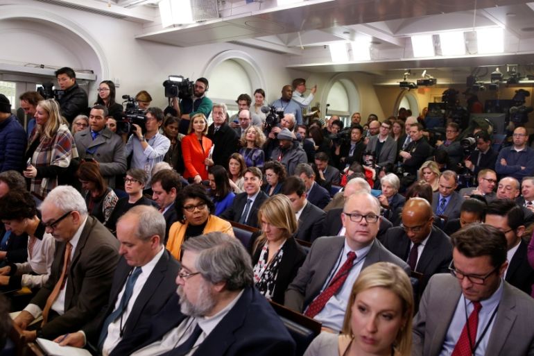 Journalists wait for U.S. President Barack Obama to start his annual year-end news conference