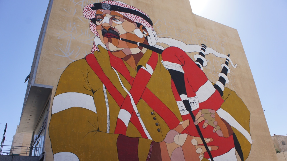 A photo of an army officer was used as inspiration for Attar's work to brighten up Khalda, northeast of Amman [Zab Mustefa/Al Jazeera]