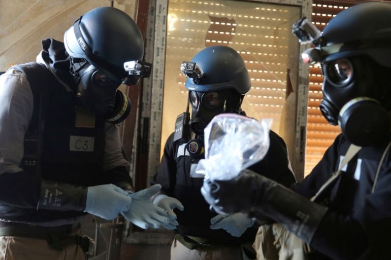 FILE PHOTO: A file photo shows a U.N. chemical weapons expert holding a plastic bag containing samples from one of the sites of an alleged chemical weapons attack in Ain Tarma