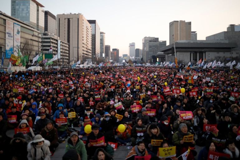 People attend a protest demanding South Korean President Park Geun-hye''s resignation on the occasion of the fourth anniversary of her inauguration, in Seoul