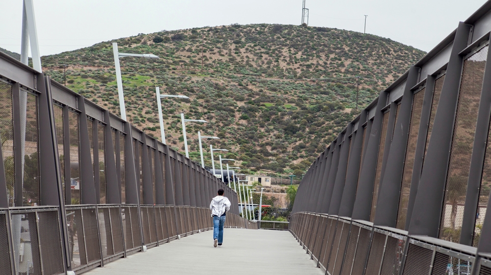 The pedestrian bridge in San Ysidro, California, crosses over the Interstate 5 freeway at the US and Mexico border between San Diego and Tijuana [Jessica Chou/Al Jazeera] 