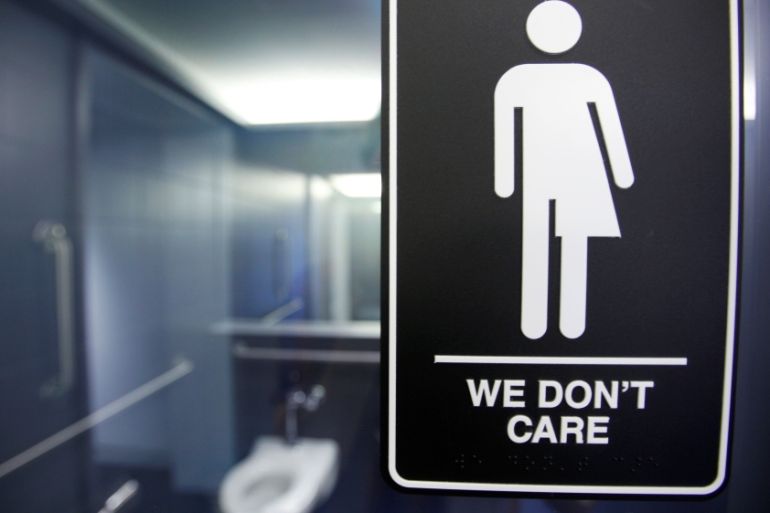 A sign protesting a recent North Carolina law restricting transgender bathroom access adorns one of the stalls at the 21C Museum Hotel in Durham, North Carolina