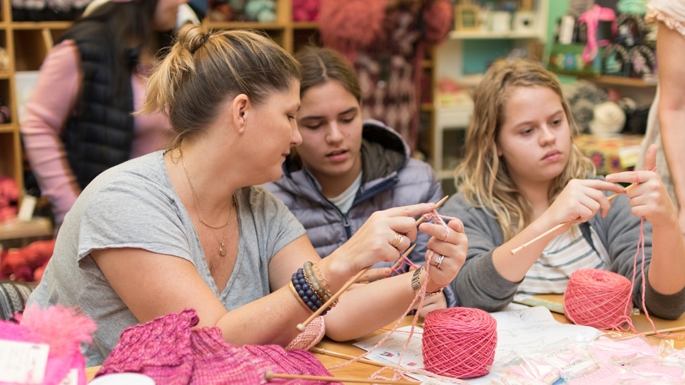 A mother and daughter learn to knit at one of the Little Knittery's special classes held in Los Angeles before the Women's March [Courtesy of Stefanie Kamerman, the Pussyhat Project]