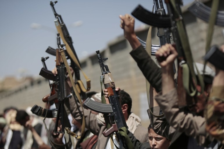 Tribesmen loyal to Houthi rebels hold their weapons in Sanaa in 2016