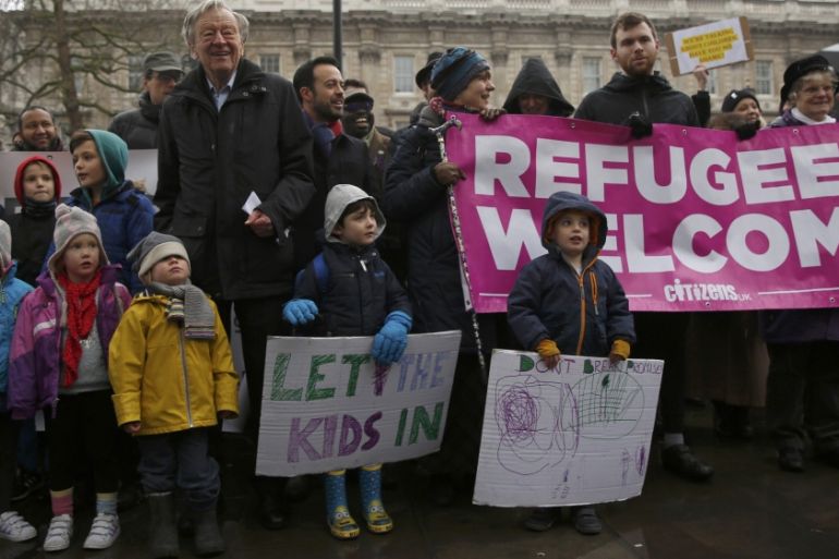Labour peer Alf Dubs poses with protestors in London as they oppose the closure of a government scheme to bring unaccompanied child refugees to Britain from Europe