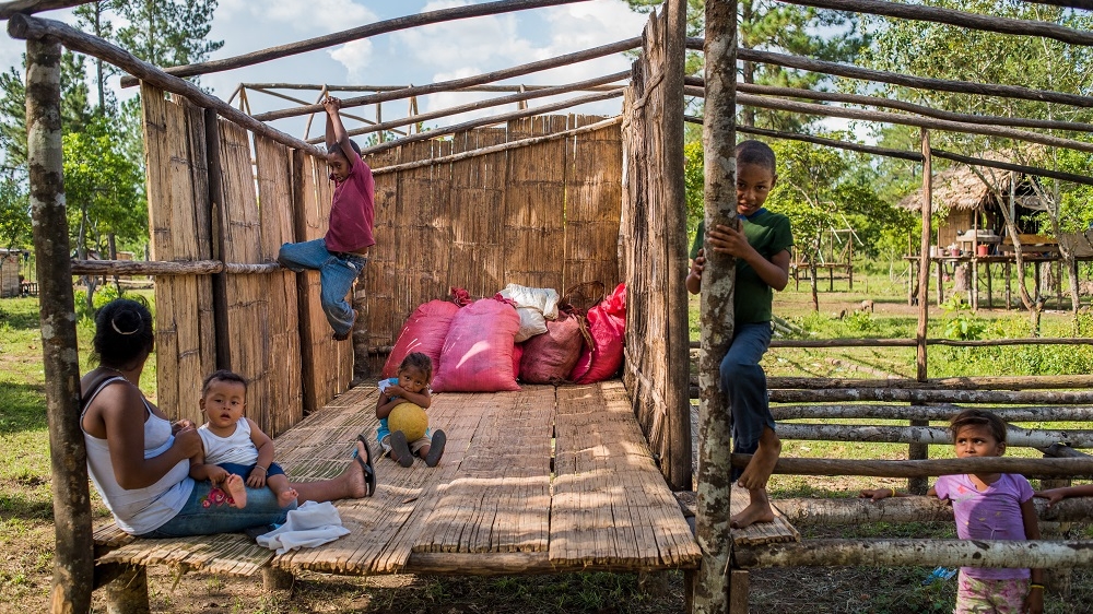 Children play inside a half-built house in the Miskito refugee community of Suji, Honduras. Families fleeing violence continue to arrive in Honduras. [Alex McDougall/Al Jazeera]