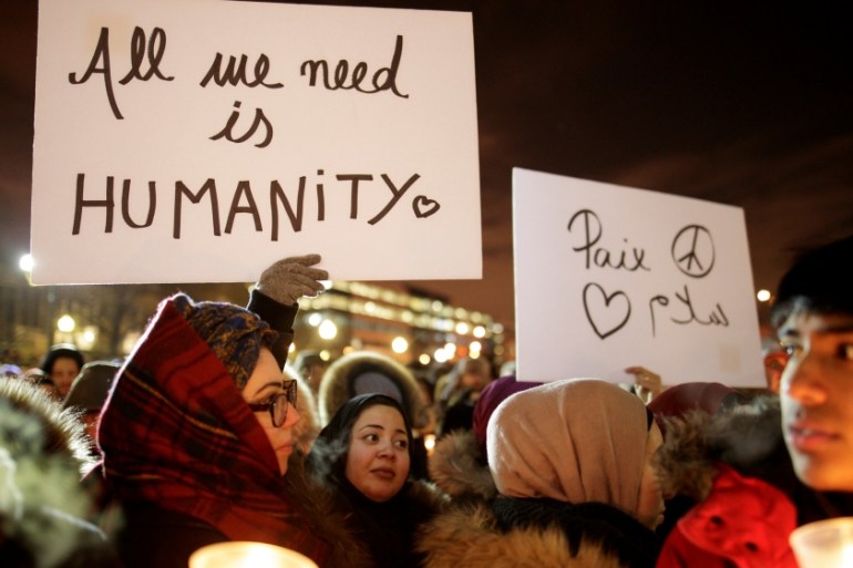 People attend a vigil in support of the Muslim community in Montreal
