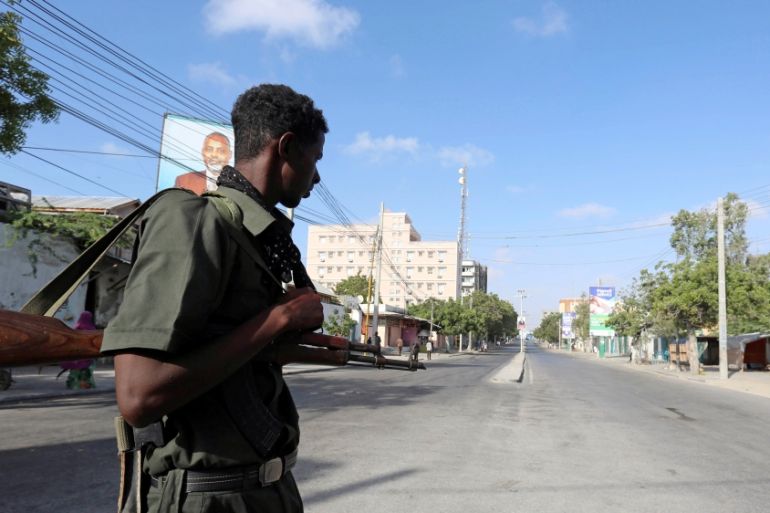 A Somali policeman stands guard along a road which was blocked to control motor vehicle traffic, during a security lock down in Mogadishu