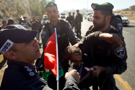 detain a Palestinian protester during a protest against a promise by U.S. President-elect Donald Trump to re-locate U.S. embassy to Jerusalem, in the West Bank near Jewish settlement of Maale Adumim