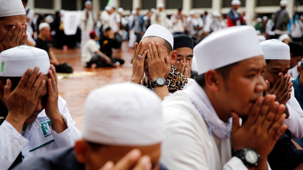 Protesters pray during a rally inside Istiqlal mosque in Jakarta [Reuters]