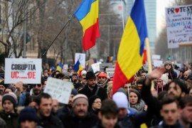 Protesters take part in a demonstration in Bucharest