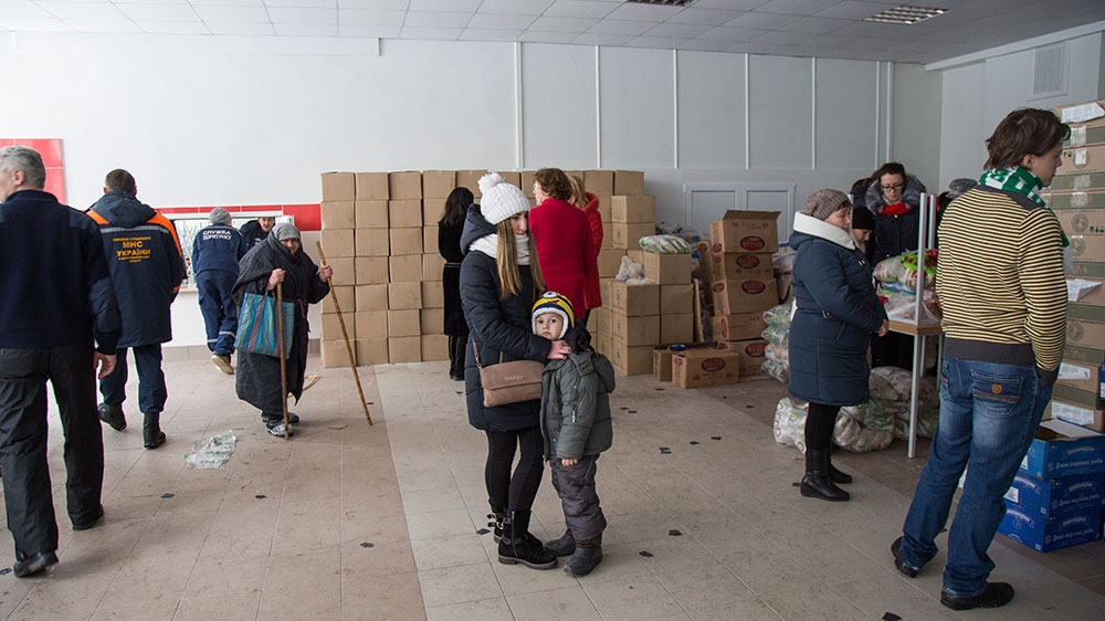 People wait for assistance in School Number 2 in Avdiivka [John Wendle/Al Jazeera] 