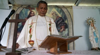 Father Elmer Cajilig and two other priests have set up their own self-styled Catholic ministry [101 East/Al Jazeera] 