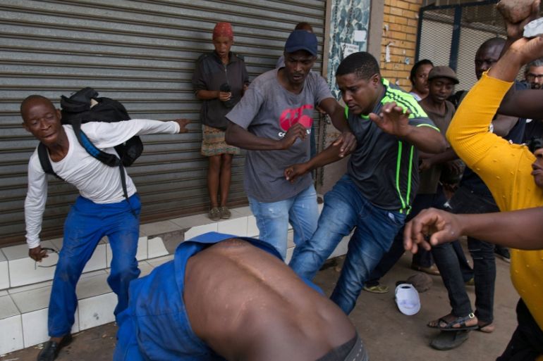 A vigilante mob attacks a Nigerian migrant outside a church in Pretoria
