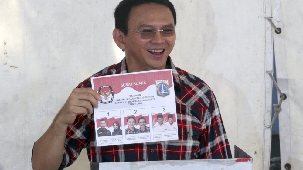 Ahok shows his ballot paper while voting in Jakarta [EPA]