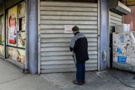 A man reads a sign announcing the closure of a bodega during a Yemeni protest against President Donald Trump''s travel ban, in the Brooklyn borough of New York City
