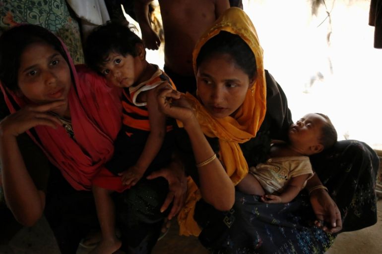 Rohingya refugee women sit inside their house with their child at Balukhali Makeshift Refugee Camp