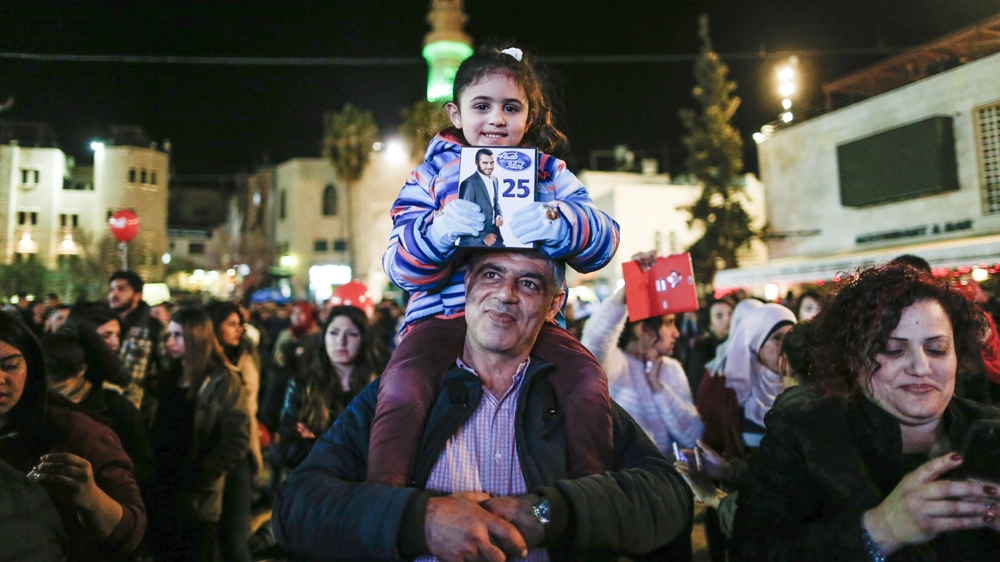 A Palestinian girl cheers from Bethlehem [Ahmad Gharbali/AFP]