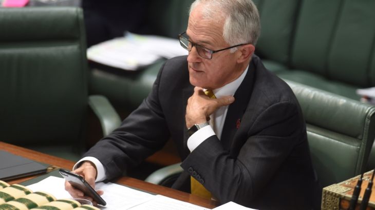 Australia''s Prime Minister Malcolm Turnbull looks at his phone