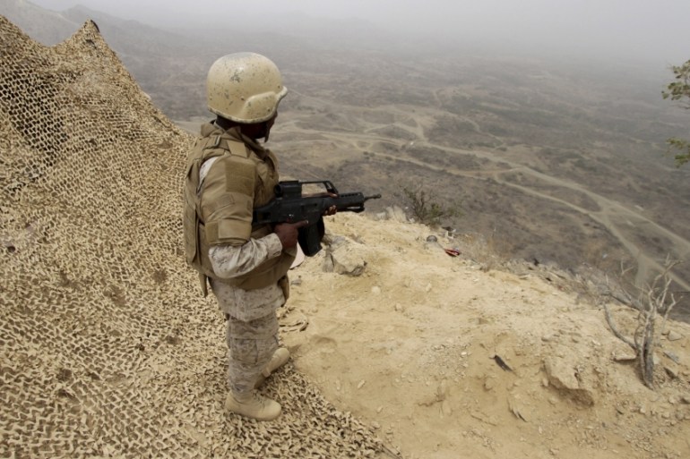 A Saudi soldier takes up a position at the Saudi border with Yemen