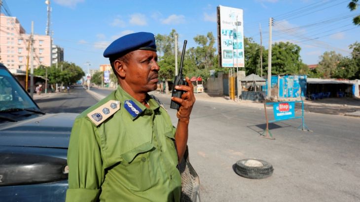 A Somali policeman stands guard along a road which was blocked to control motor vehicle traffic, during a security lock down in Mogadishu