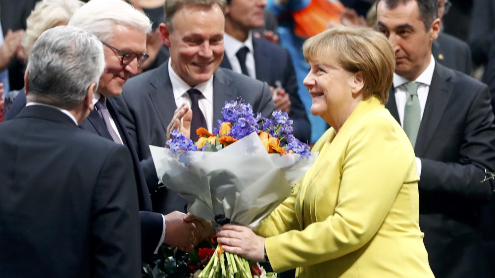 Steinmeier receives congratulations from German Chancellor Angela Merkel [Fabrizio Bensch/Reuters]