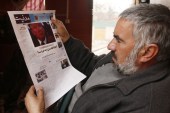 An Afghan man reads a local newspapers carrying front page news of the inauguration of US President Donald Trump in Kabul, Afghanistan, January 22 [Jawad Jalali/EPA]