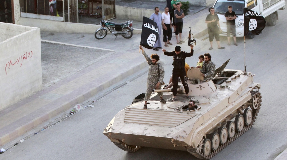 ISIL fighters take part in a military parade along the streets of northern Raqqa province June 30, 2014 [Reuters]