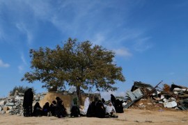 Arab Israeli women sit next to ruins from their dwellings which were demolished by Israeli bulldozers in Umm Al-Hiran, a Bedouin village in Israel''s southern Negev Desert