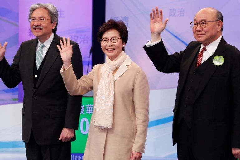 Chief Executive candidates John Tsang, Carrie Lam and Woo Kwok-hing pose before a debate in Hong Kong