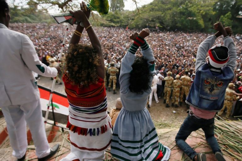 Demonstrators chant slogans while flashing the Oromo protest gesture during Irreecha, the thanksgiving festival of the Oromo people, in Bishoftu town, Oromia region, Ethiopia