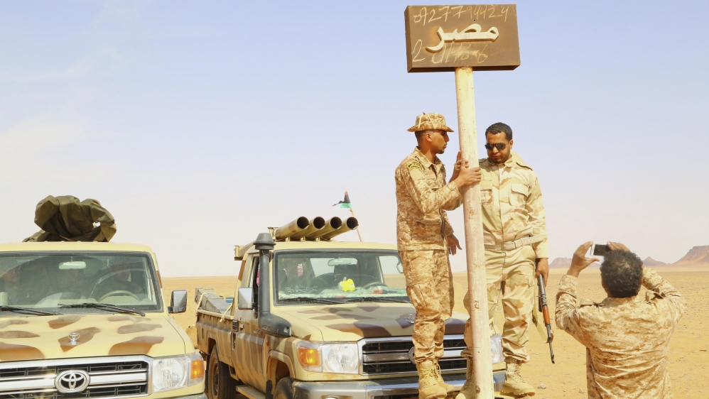 Troops from the LNA stand next to an Egypt sign; supported by Egypt and Russia, Haftar's army took over most of East Libya [Reuters]
