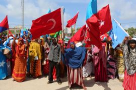 Somali people carry Turkish and Somali flags as they gather in support of Turkish President Tayyip Erdogan and his government in Somalia''s capital Mogadishu