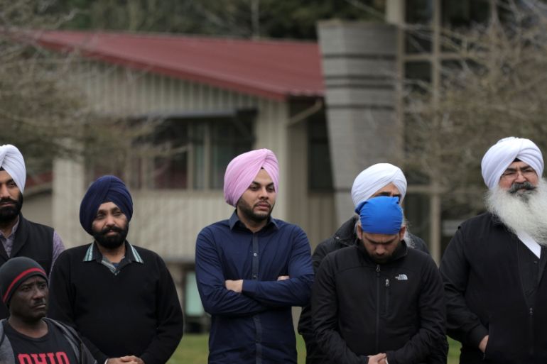 Sikh men listen during a vigil in honor of Srinivas Kuchibhotla, an immigrant from India who was recently shot and killed in Kansas, at Crossroads Park in Bellevue, Washington