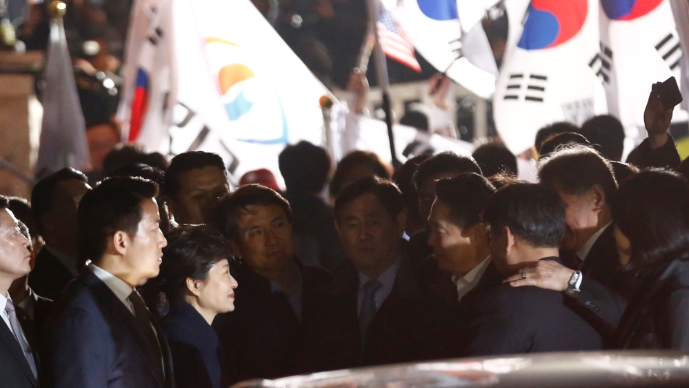Hundreds of flag-waving supporters waited for the former South Korean leader outside her private home [Reuters]