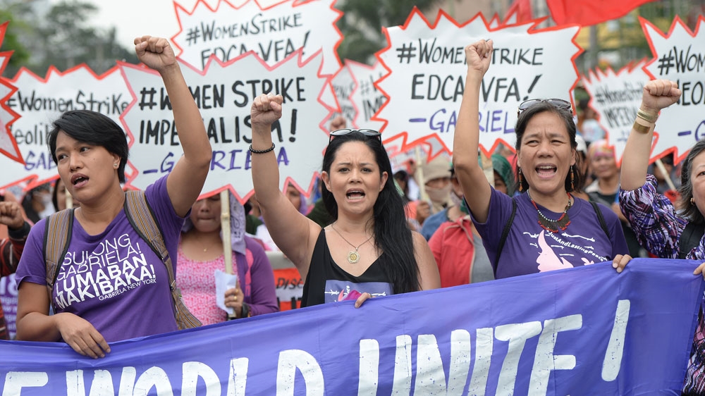Women march in the Philippine capital, Manila, to demand equal rights. [Ted Aljibe/AFP]