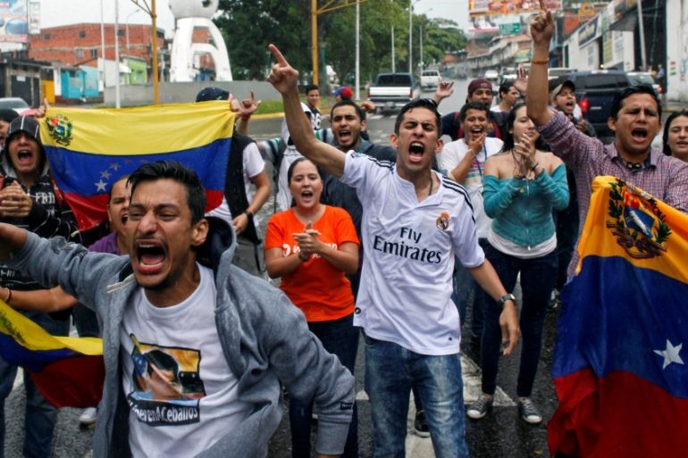 Opposition supporters shout slogans during a protest against Venezuelan President Nicolas Maduro''s government in San Cristobal