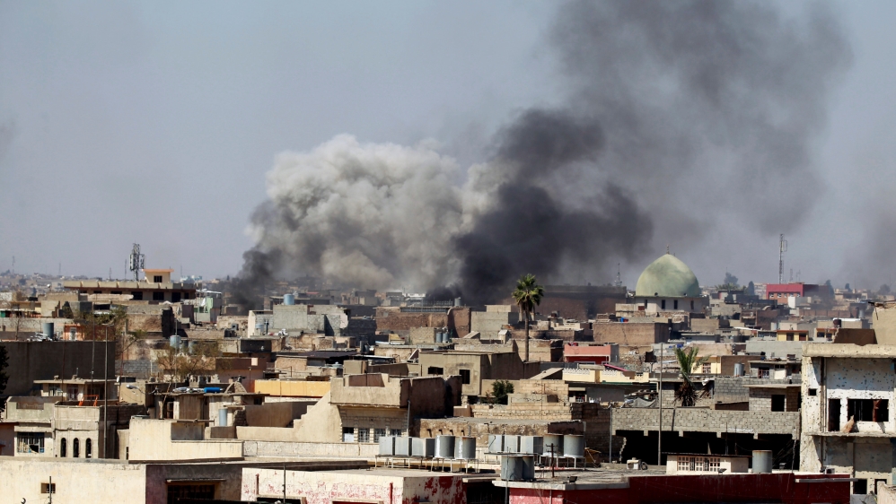Smoke rises over Mosul during clashes between Iraqi forces and ISIL fighters on Saturday [Khalid al Mousily/Reuters]