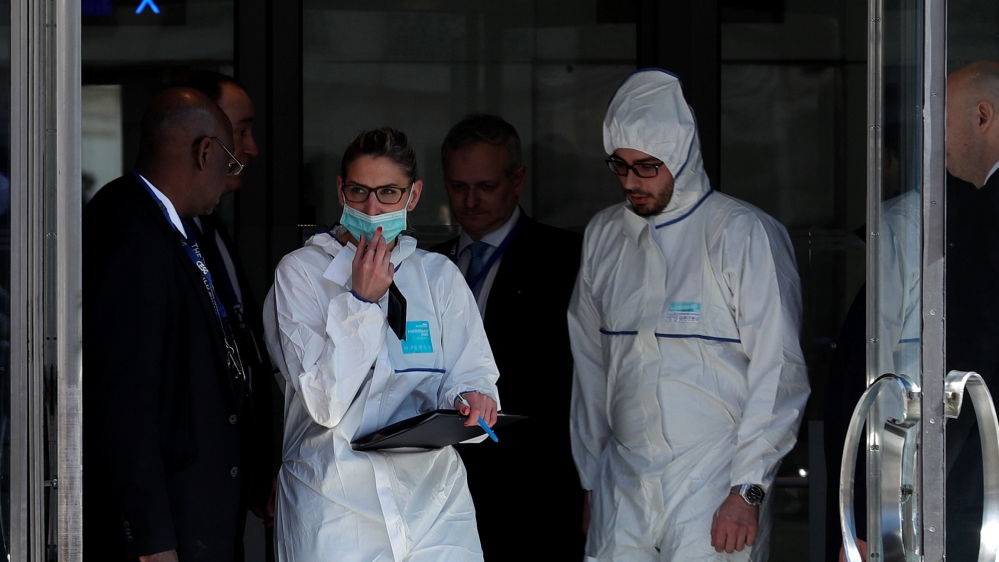 Police investigators leave IMF offices in central Paris [Christian Hartmann/Reuters]