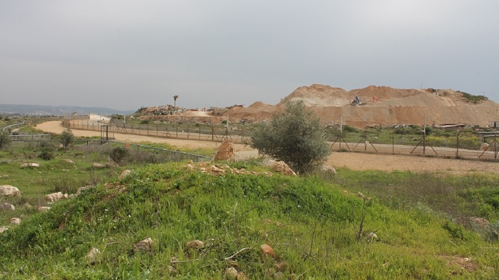 The separation barrier has cuts Kharbata village off from its privately owned land, some of which was confiscated by the Israeli state for the settlement of Modiin Illit [Nigel Wilson/Al Jazeera]