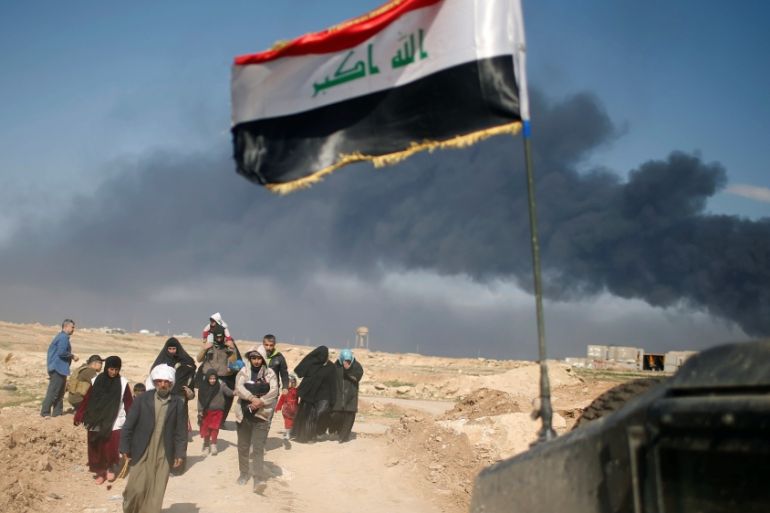 Displaced Iraqis flee their homes as Iraqi forces battle with Islamic State militants, in western Mosul