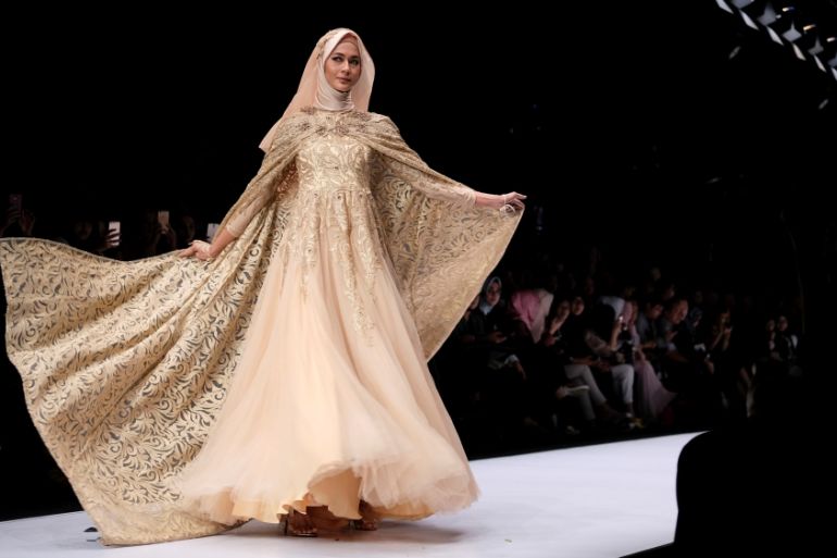 A model presents a Muslim wear by Indonesian designer Qonita Gholib during the Jakarta Fashion Week in Jakarta