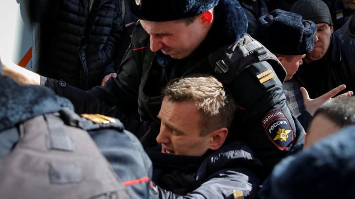 Police officers detain anti-corruption campaigner and opposition figure Alexei Navalny during a rally in Moscow, Russia