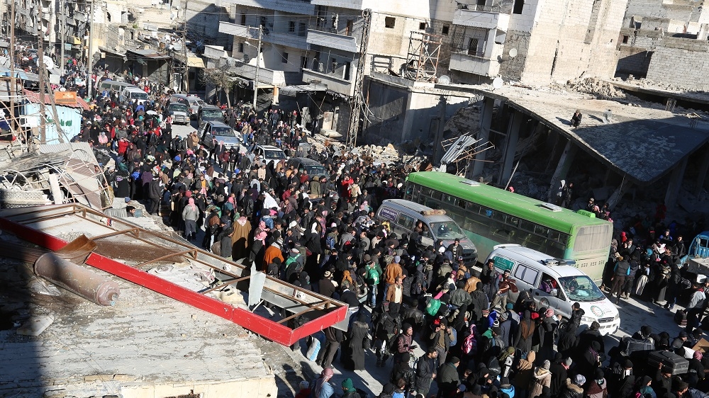 Thousands of east Aleppo residents prepare to board buses to leave the besieged city [Malek Al Shimale/Al Jazeera]
